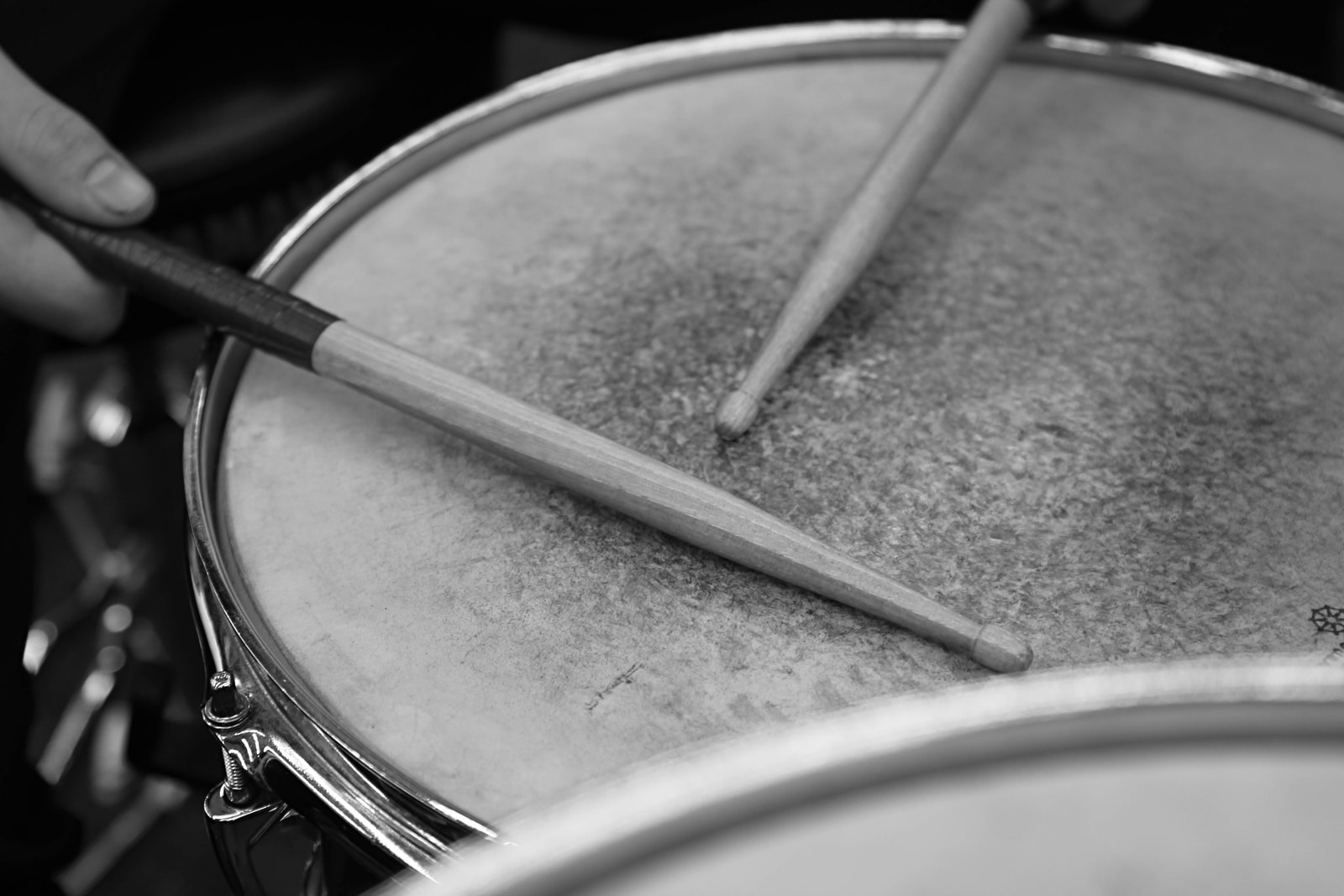 gray scale photo of drum sticks